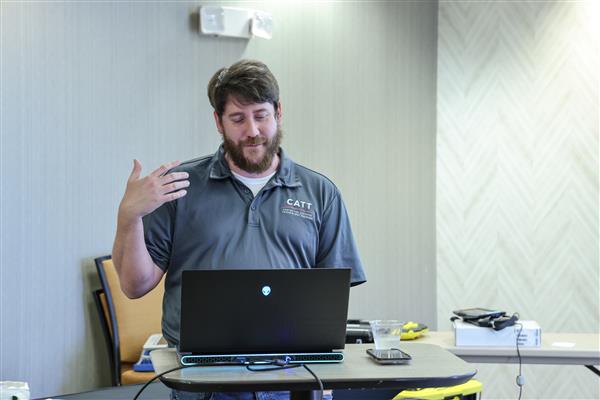 Trainer Jason Martin standing at computer speaking